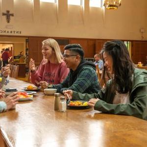 Students laugh over lunch